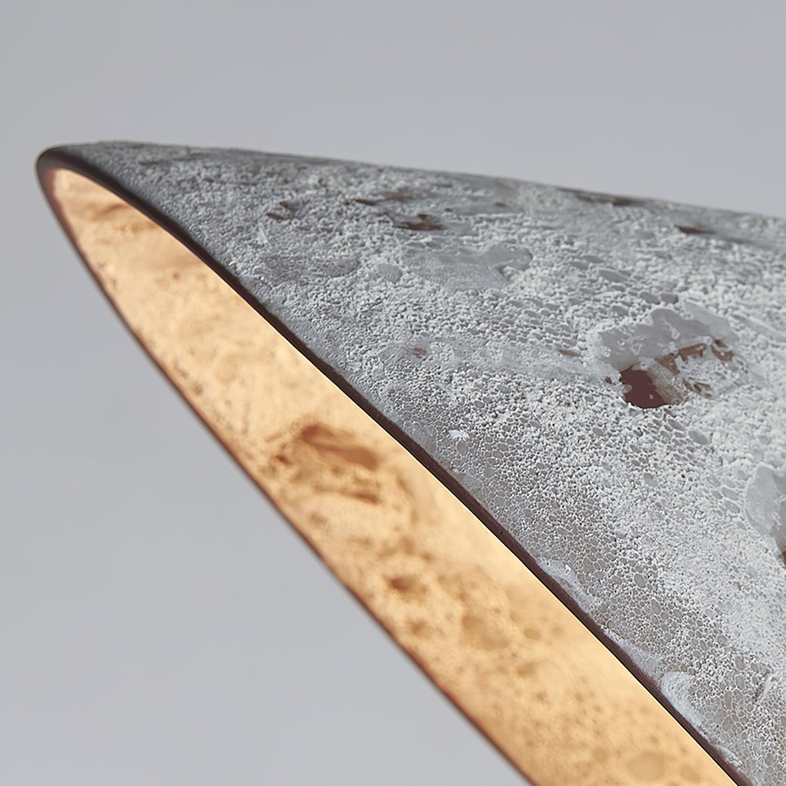 Macro detail of coarse white ceramic texture, brown mottled patches and the thin shade rim with a glowing inner face