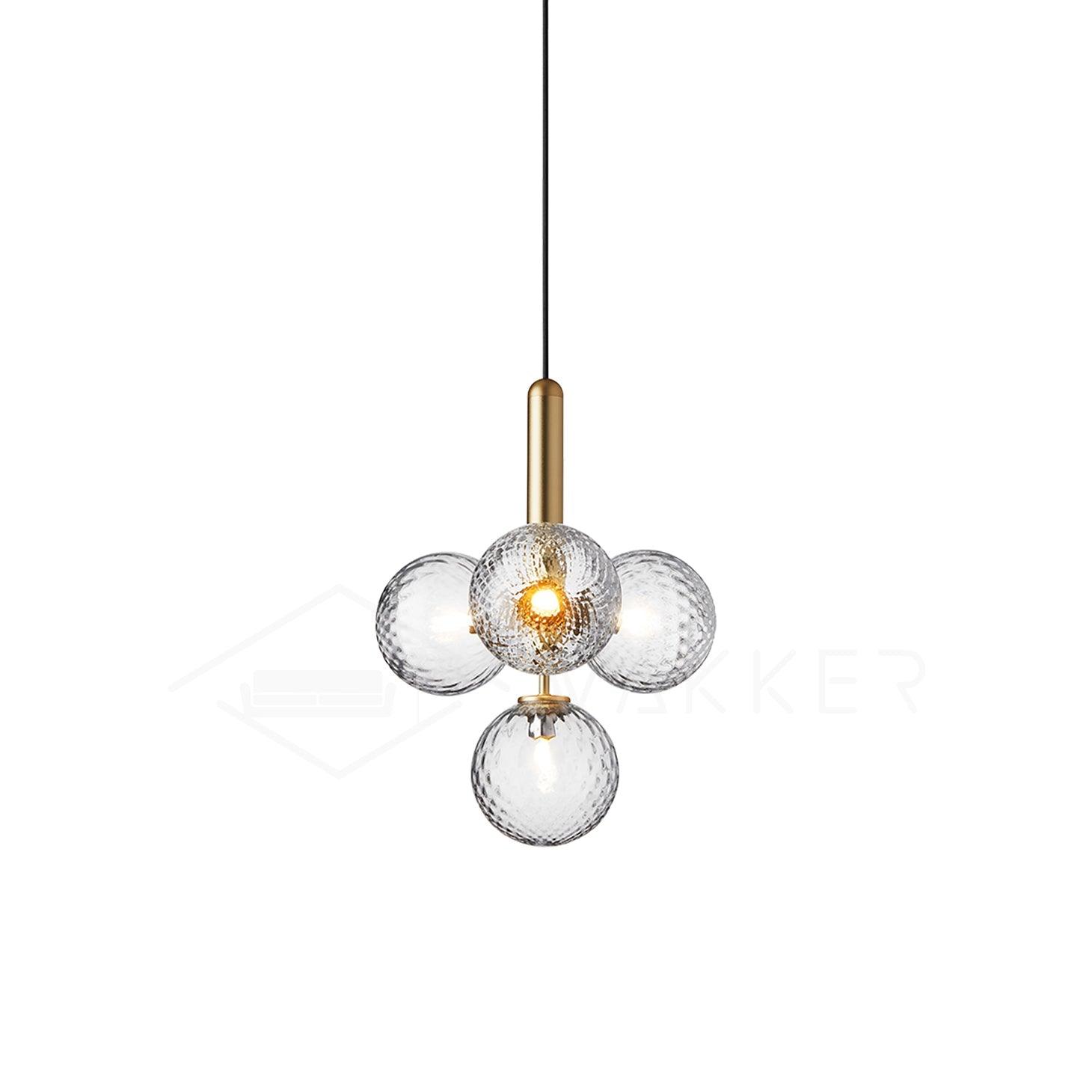 Compact cluster of patterned clear glass globes around a central brass stem