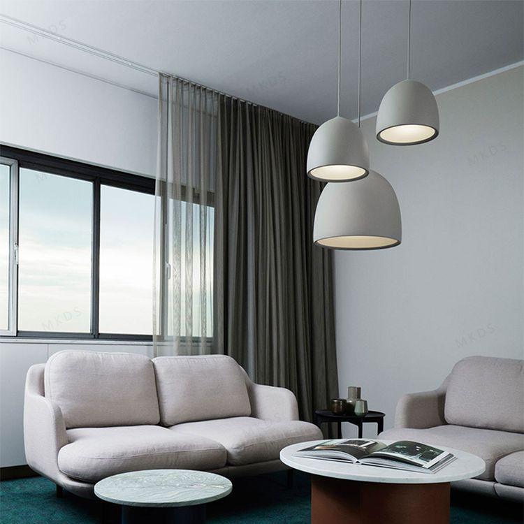Three pale bell pendants hanging at different heights