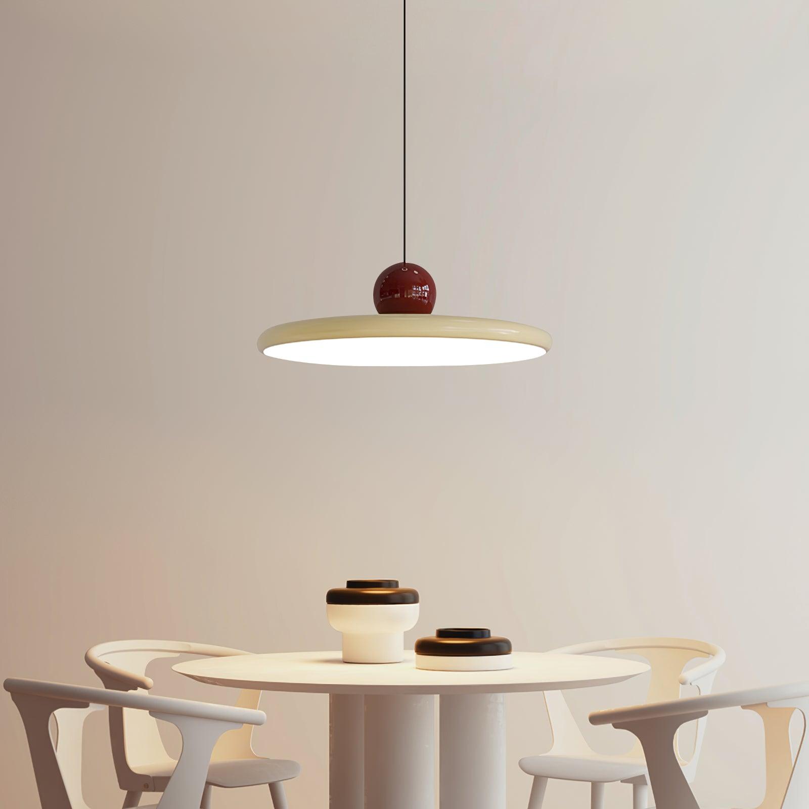 Red and Beige Lola pendant above a white round table