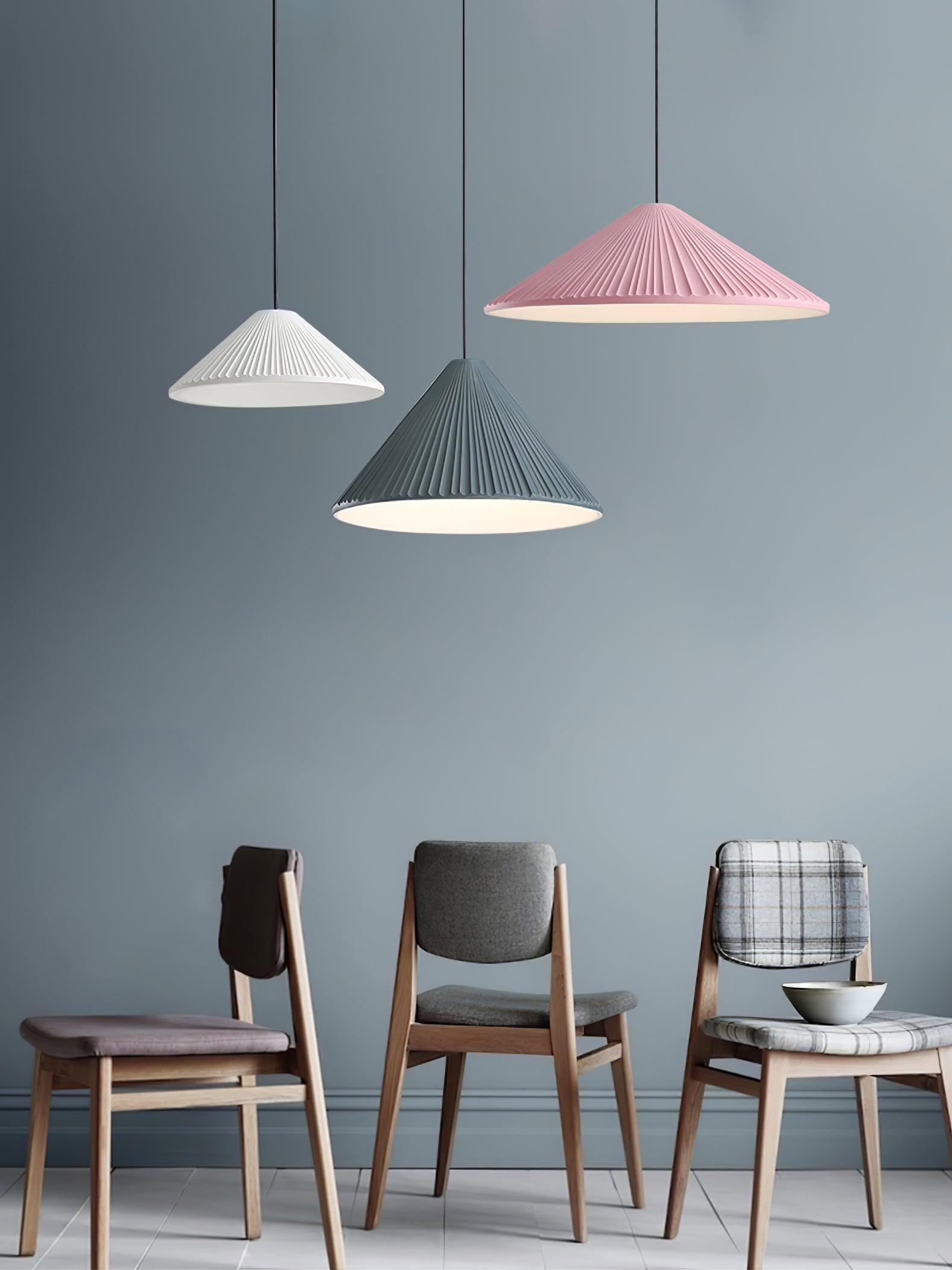 Coloured Hat pendants above dining chairs