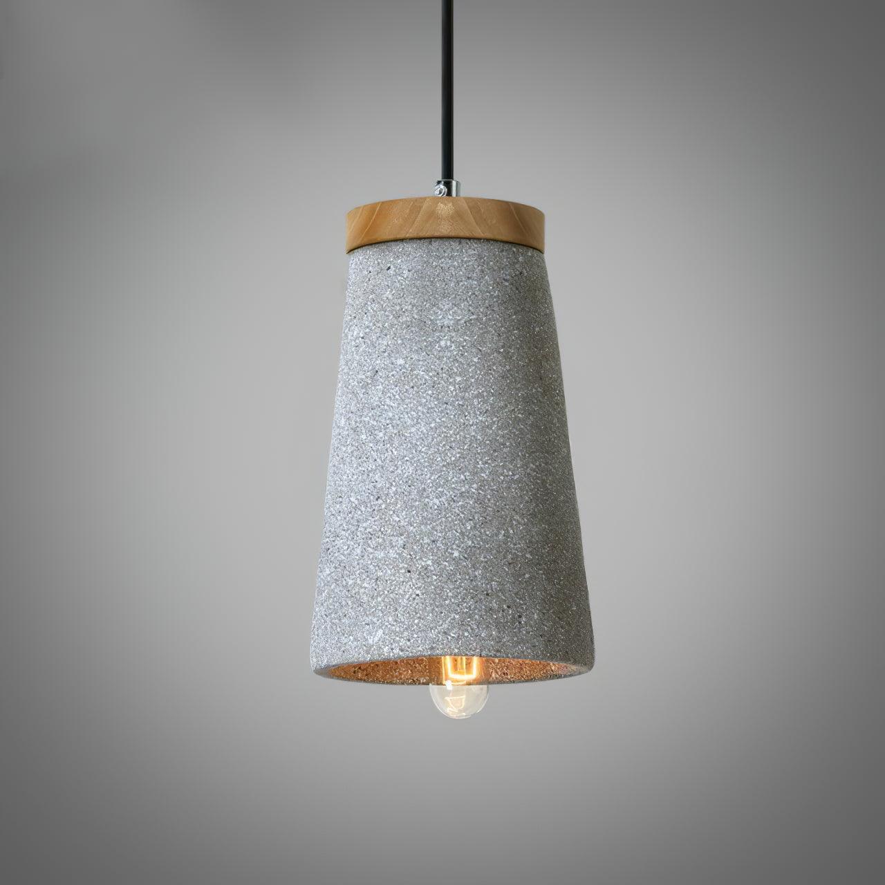 Light grey speckled cement shade with a wooden top and a bulb visible beneath the rim