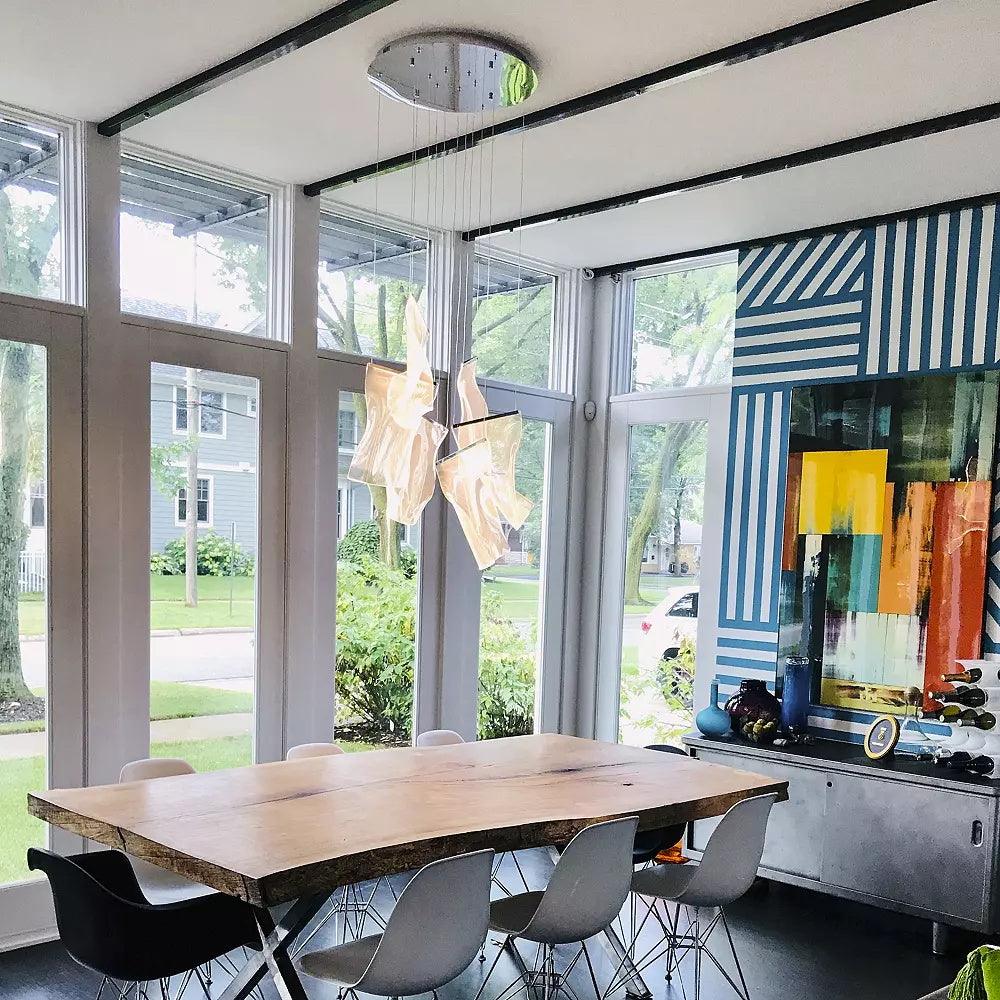 Small acrylic pendant group above a wooden dining table