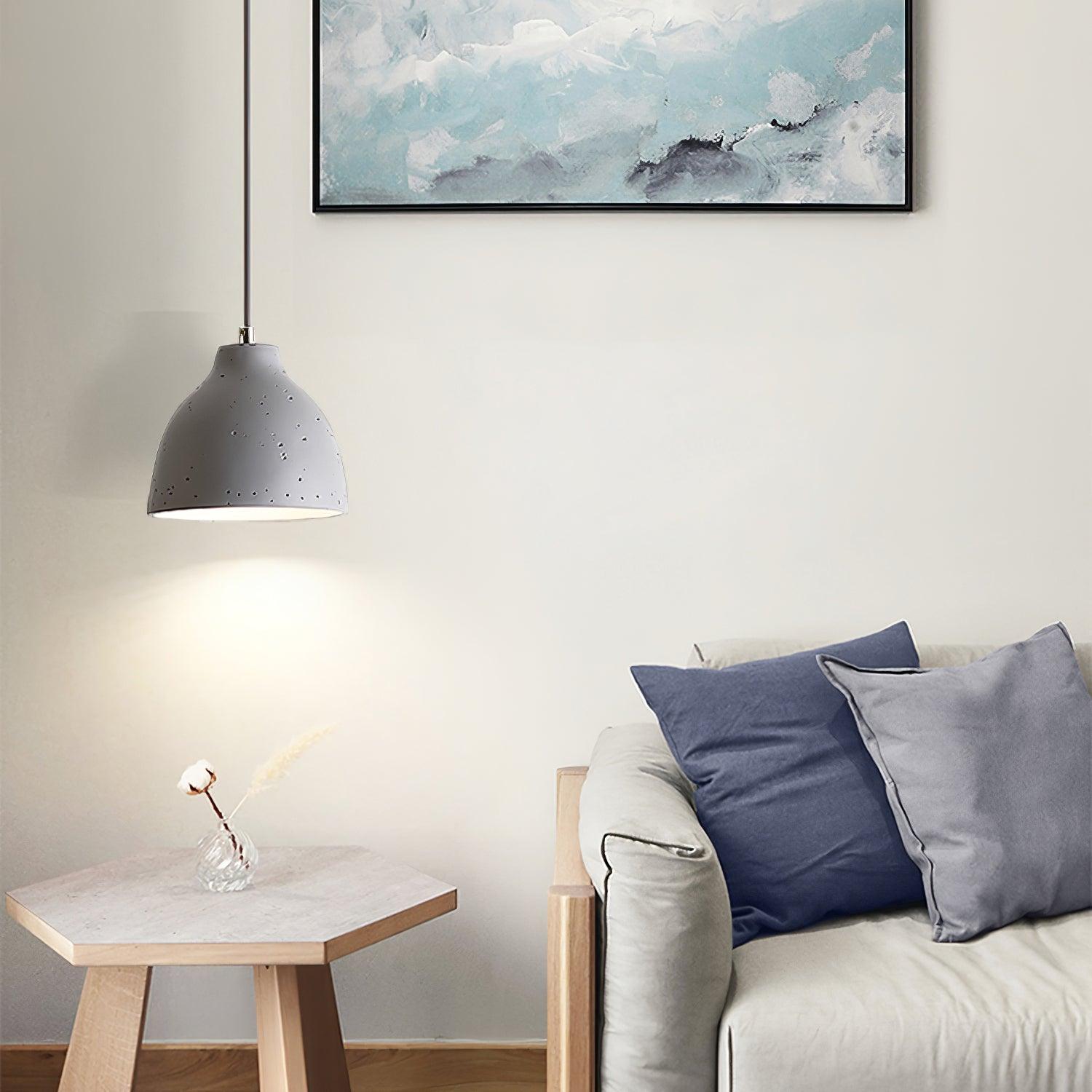 Grey bowl pendant beside a sofa