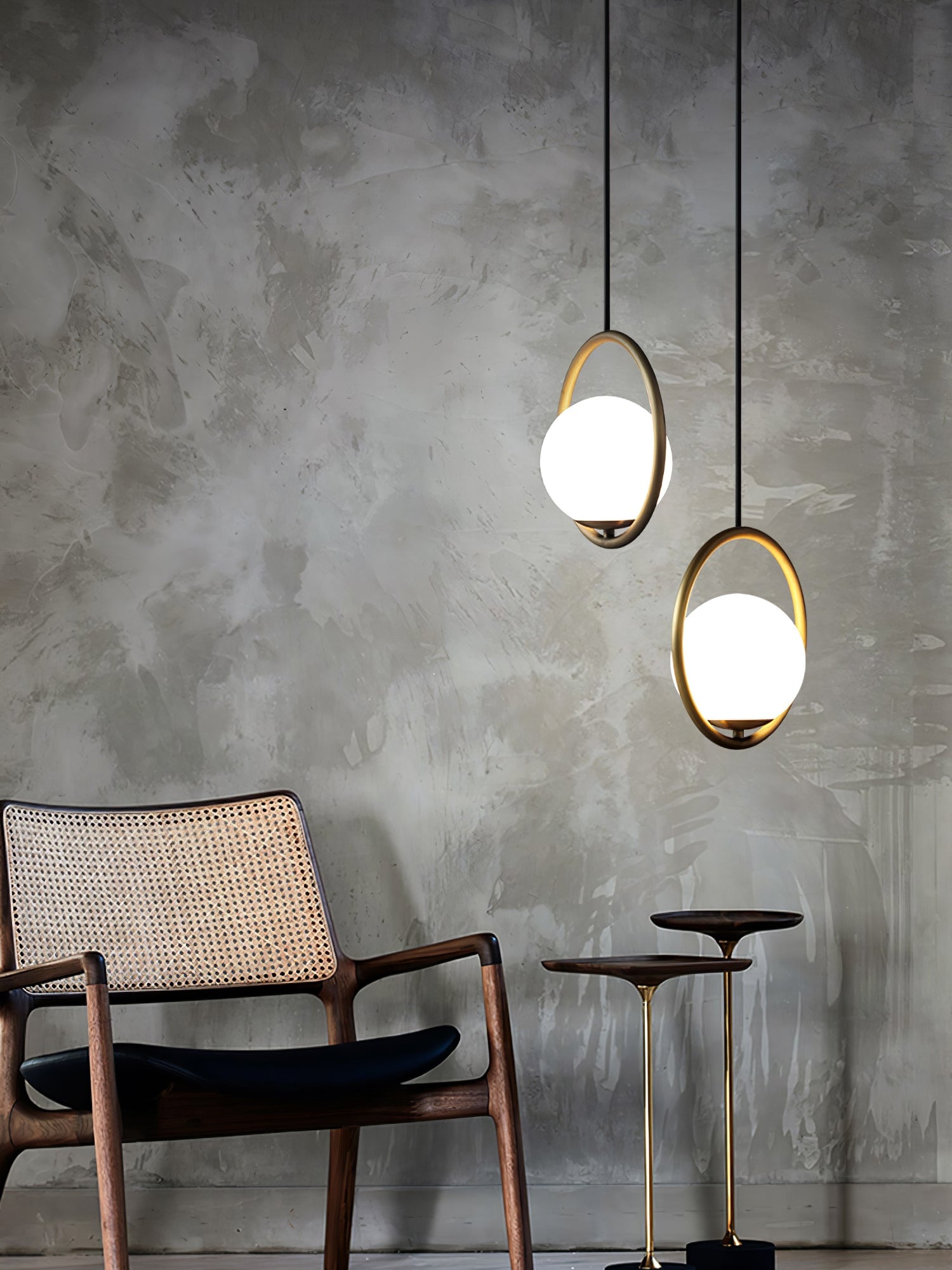Two circular globe pendants beside an armchair
