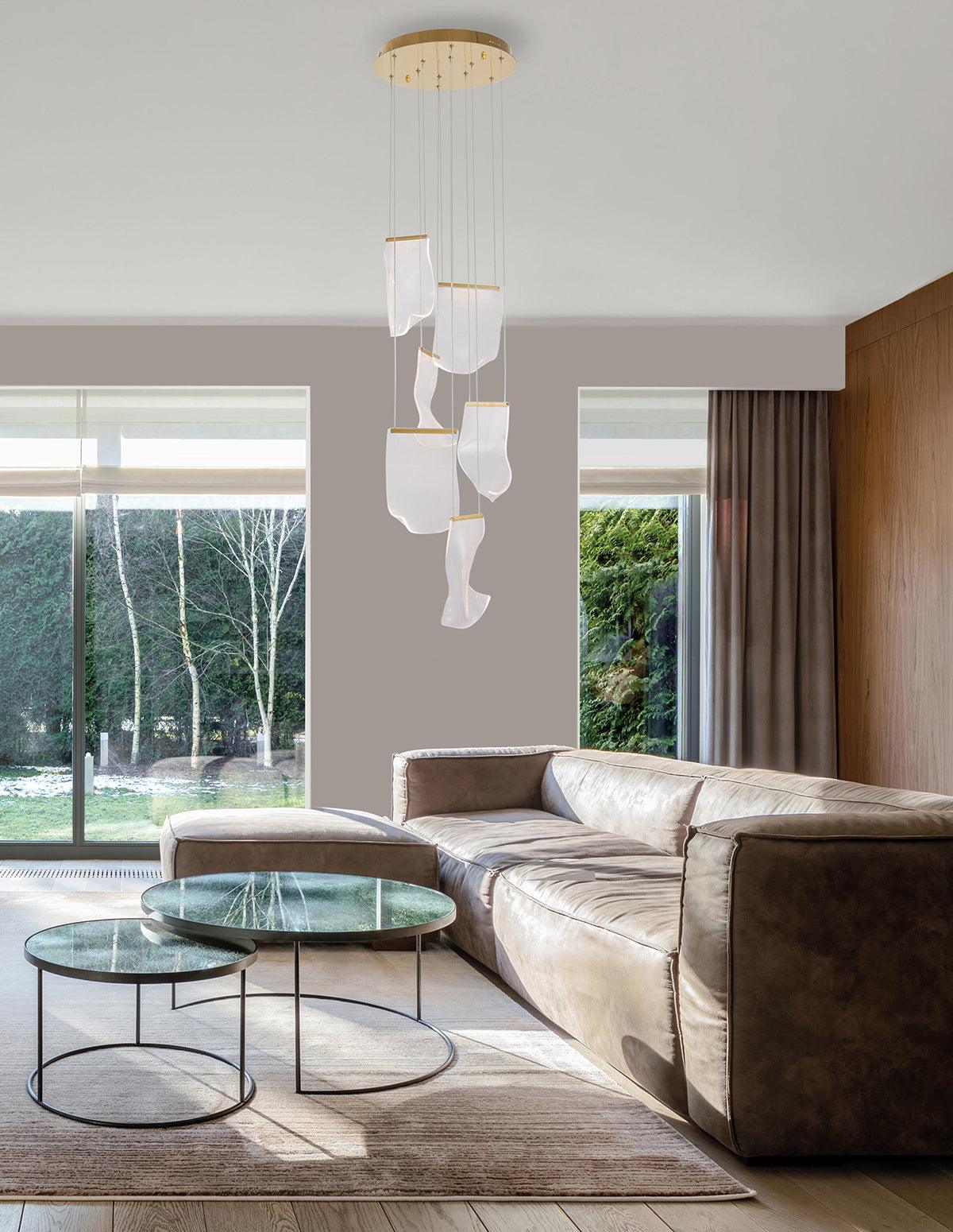 Small acrylic cascade above a sofa near a window