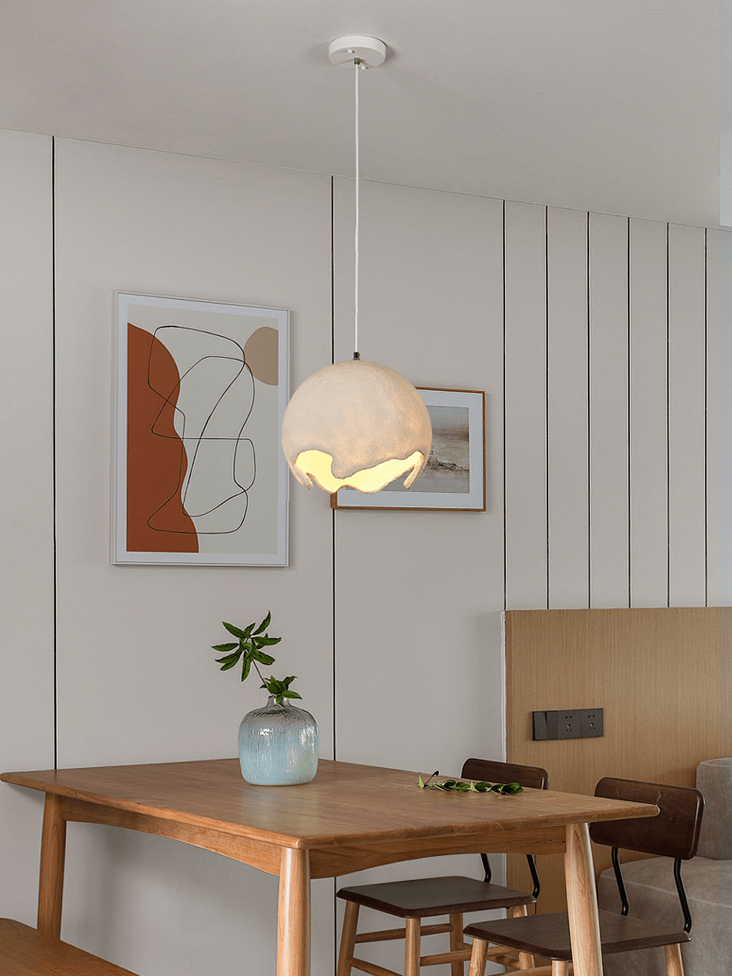 Single beige pendant above a wooden table