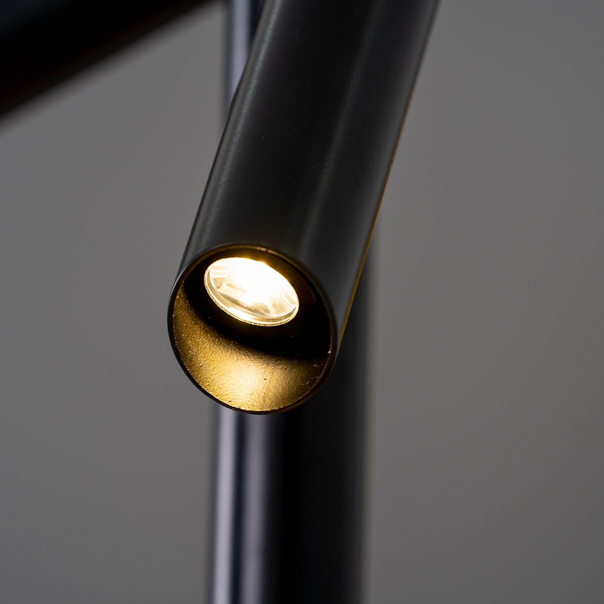 Close-up of an illuminated recessed light at the angled end of a black Tubes arm