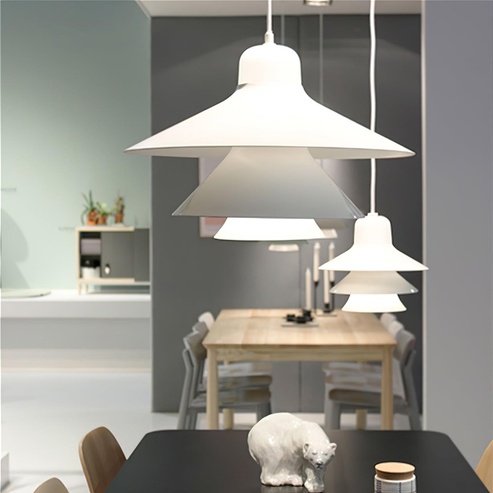 White layered pendants above dining furniture