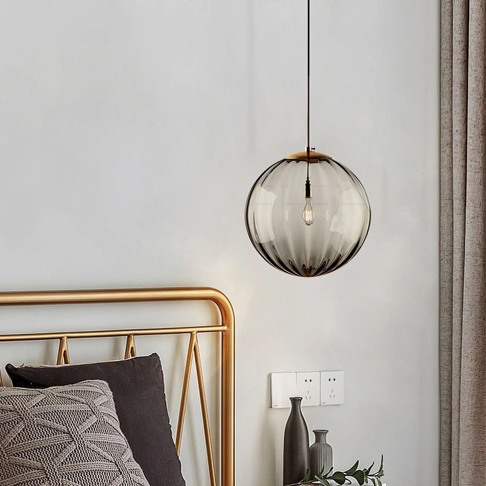 Paola pendant light with a coloured glass globe and small metal cap