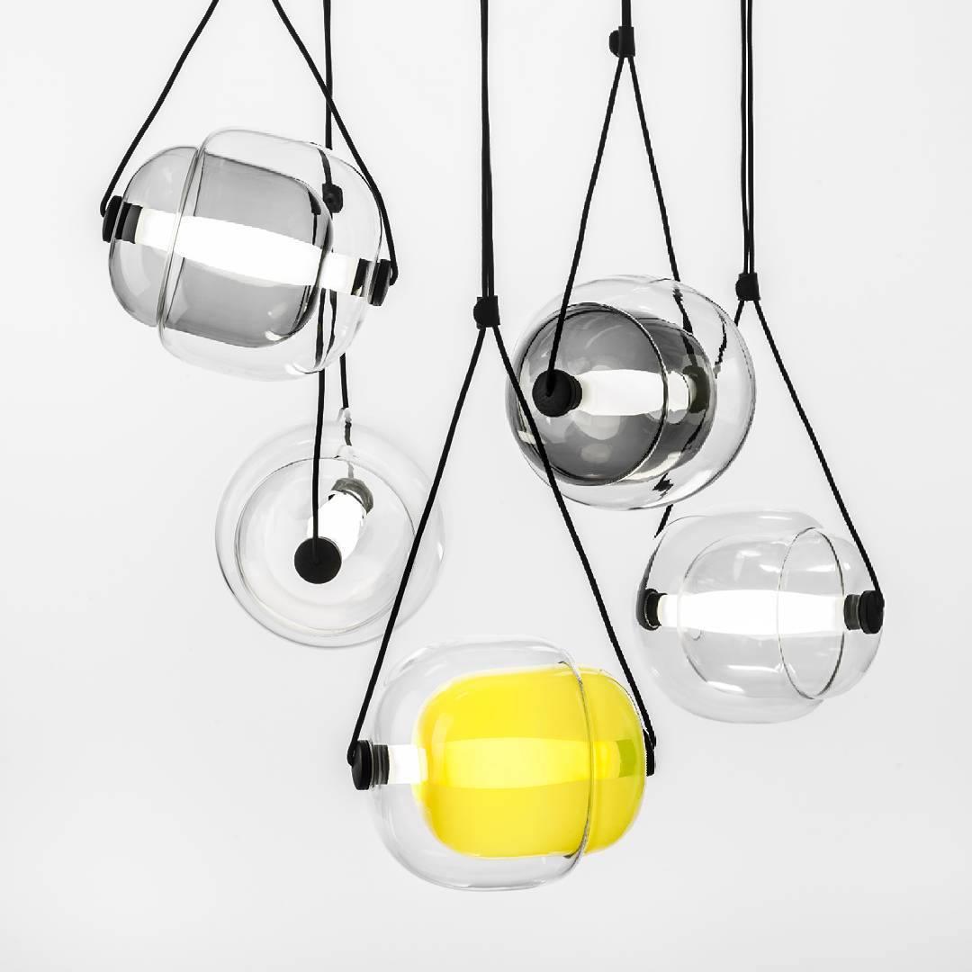 Clear smoky and yellow glass pendants on dark straps
