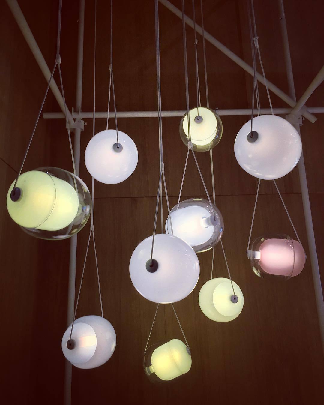 Several softly illuminated rounded pendants