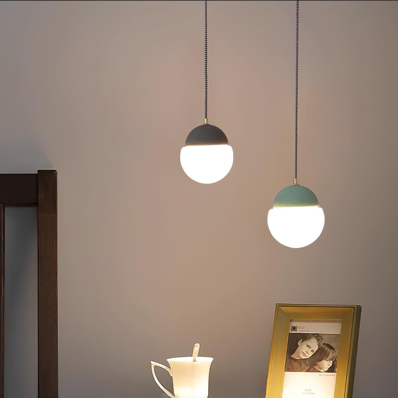 Dark and Green cap pendants above a console