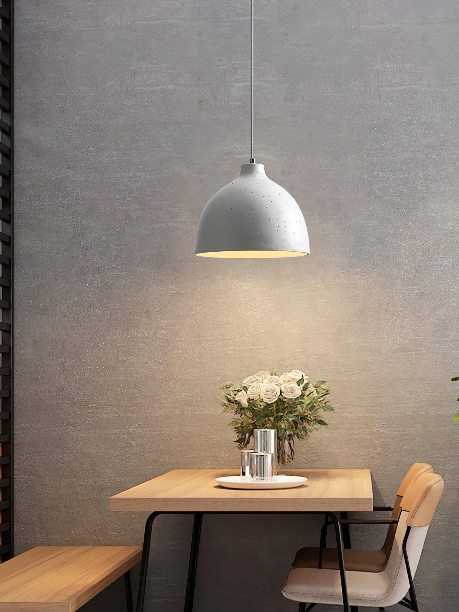 White pendant above a small café-style table