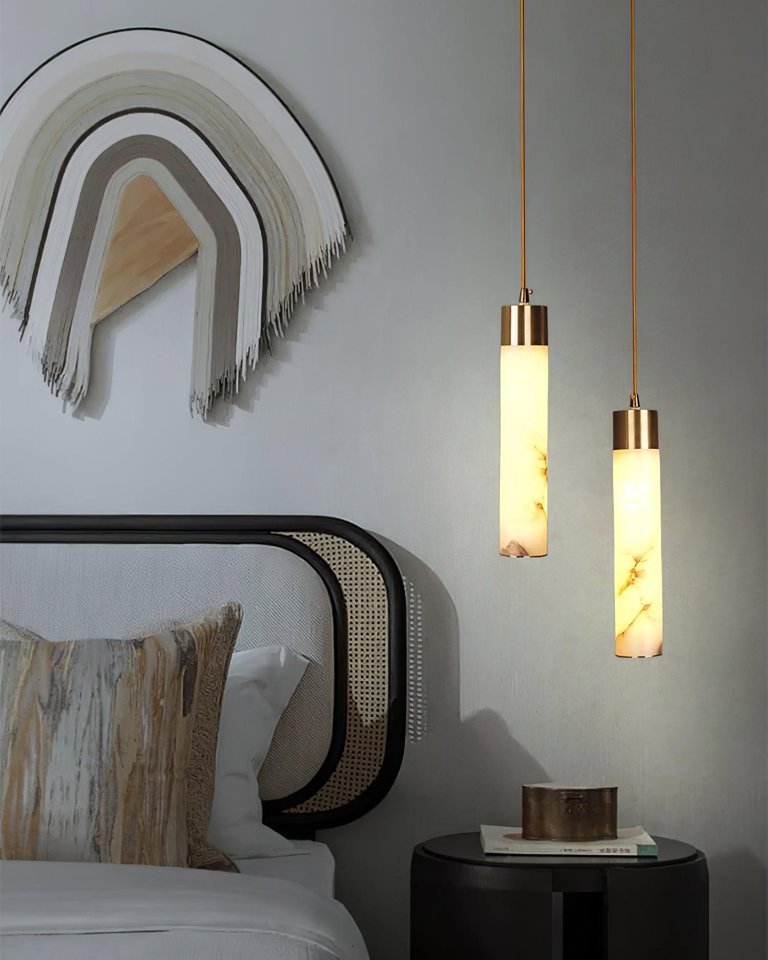Tala tube pendants beside a bed and wall artwork