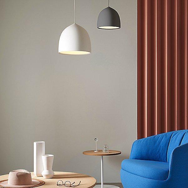 White and grey pendants beside a blue chair