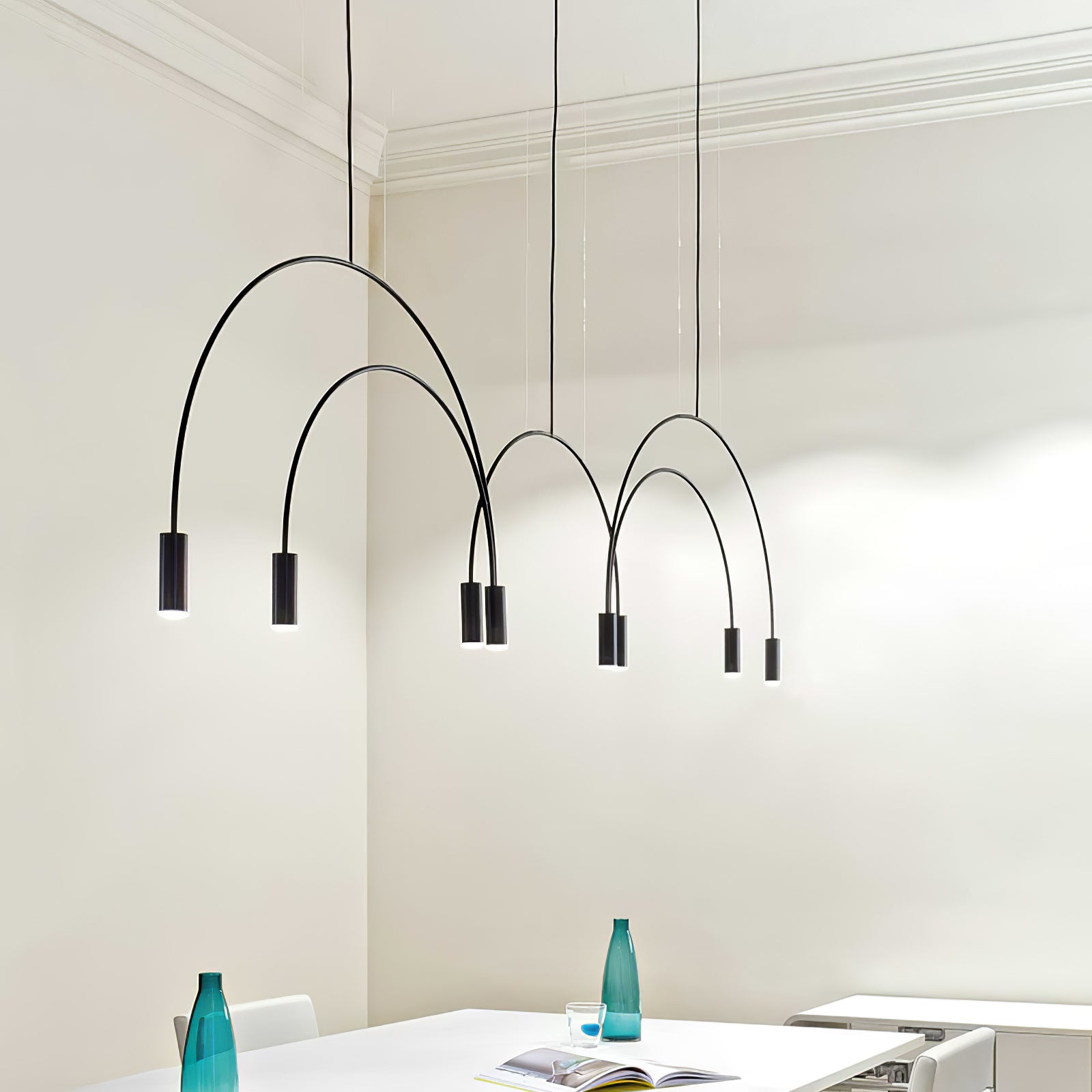 Black multi-head arcs above a kitchen table