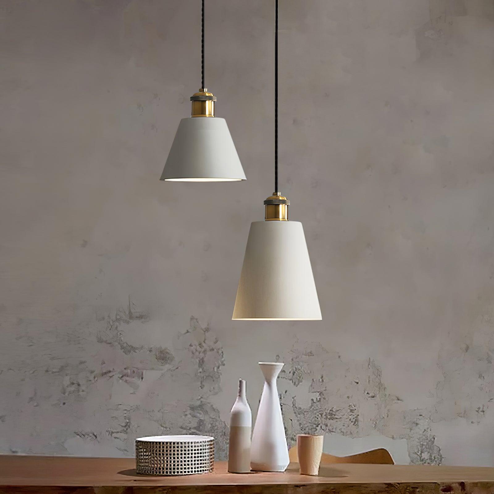 Two light-coloured cone shades near a textured wall
