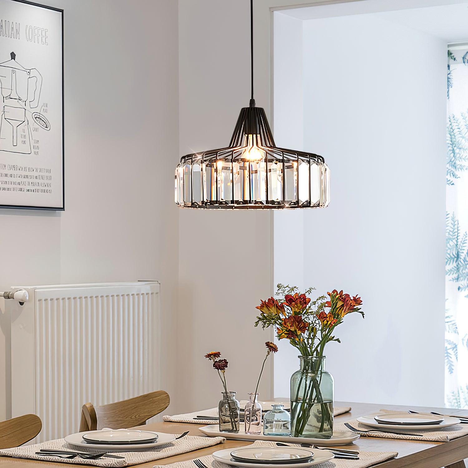 Black drum pendant above a dining table with flowers
