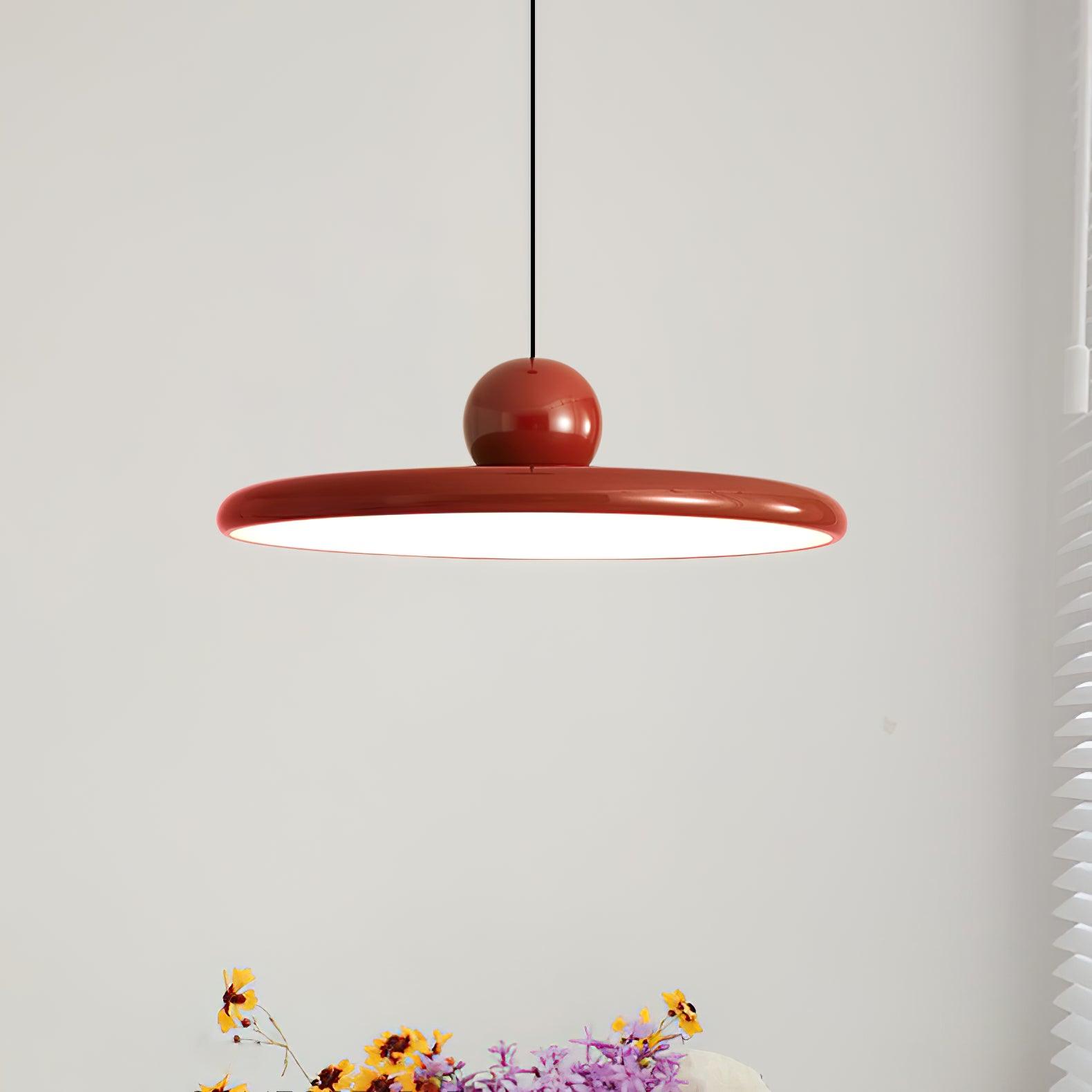 Red Lola disc pendant over colourful flowers