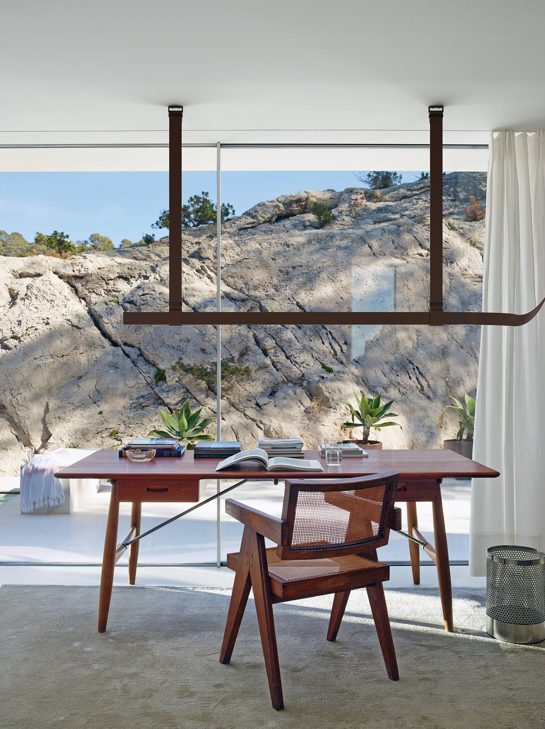 Brown Belt pendant above a table facing a rocky landscape
