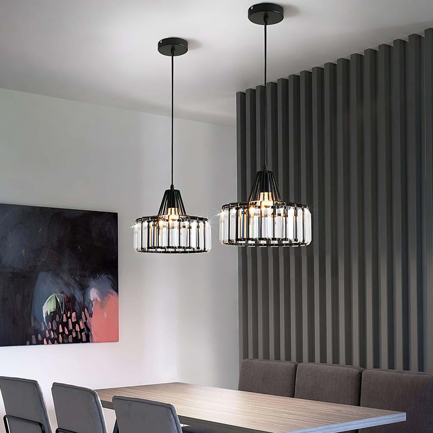 Two black pendants above a dining table beside a ribbed wall