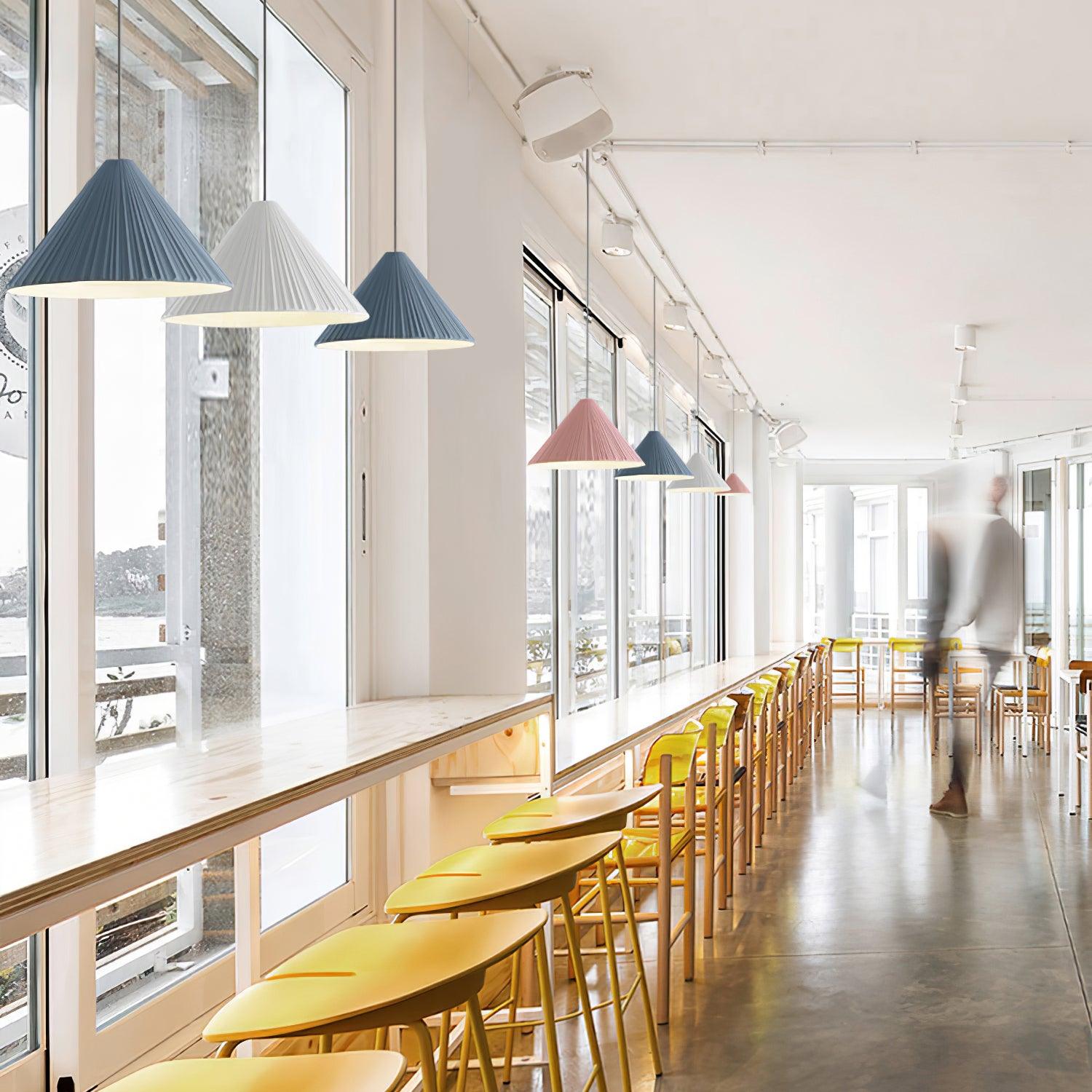 Coloured Hat pendants along a window counter