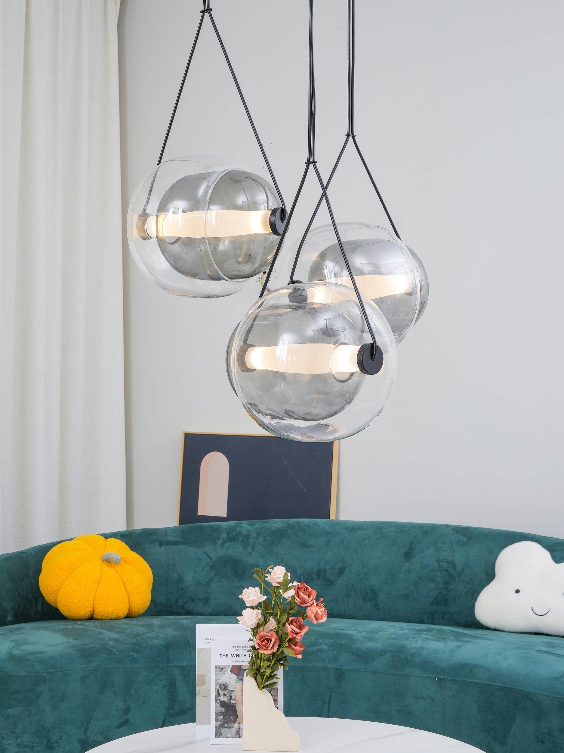 Clear Capsula pendants beside white curtains
