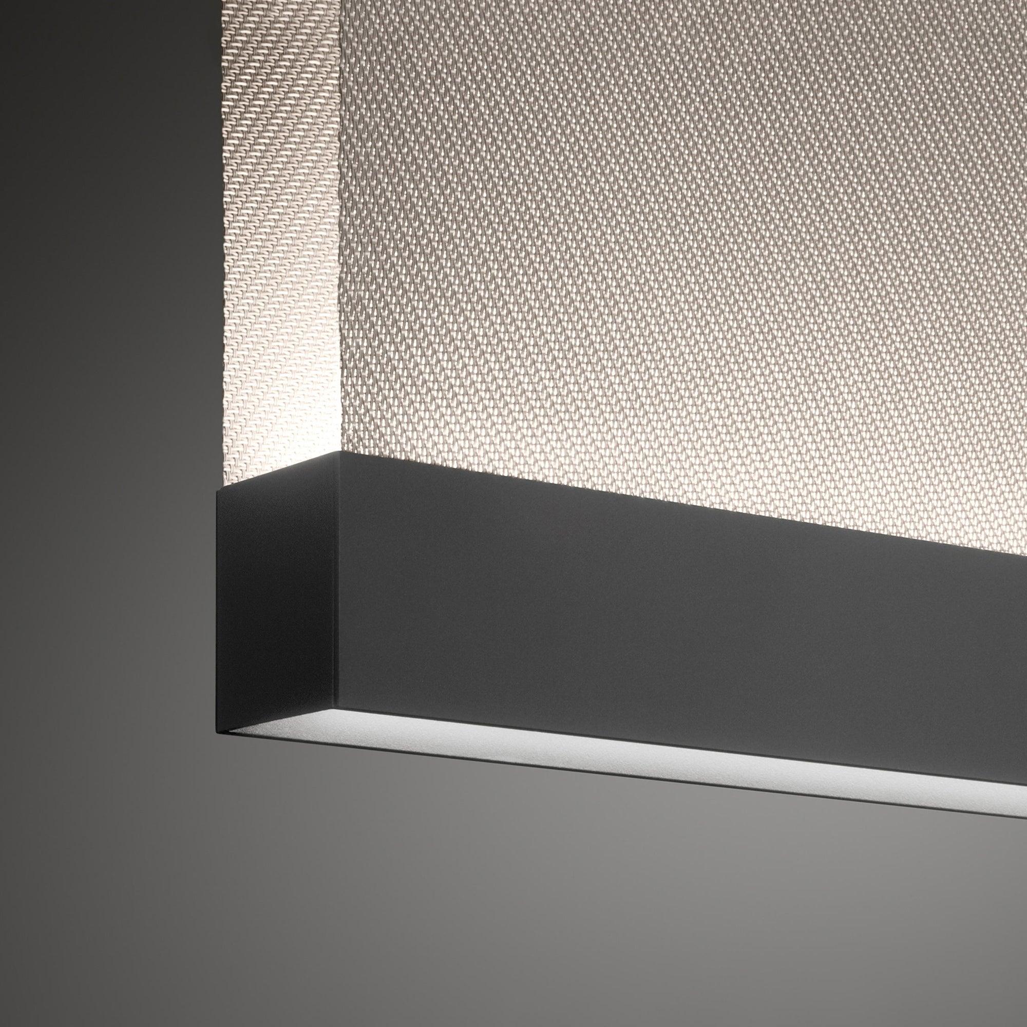 Black metal lower rail beneath woven fabric