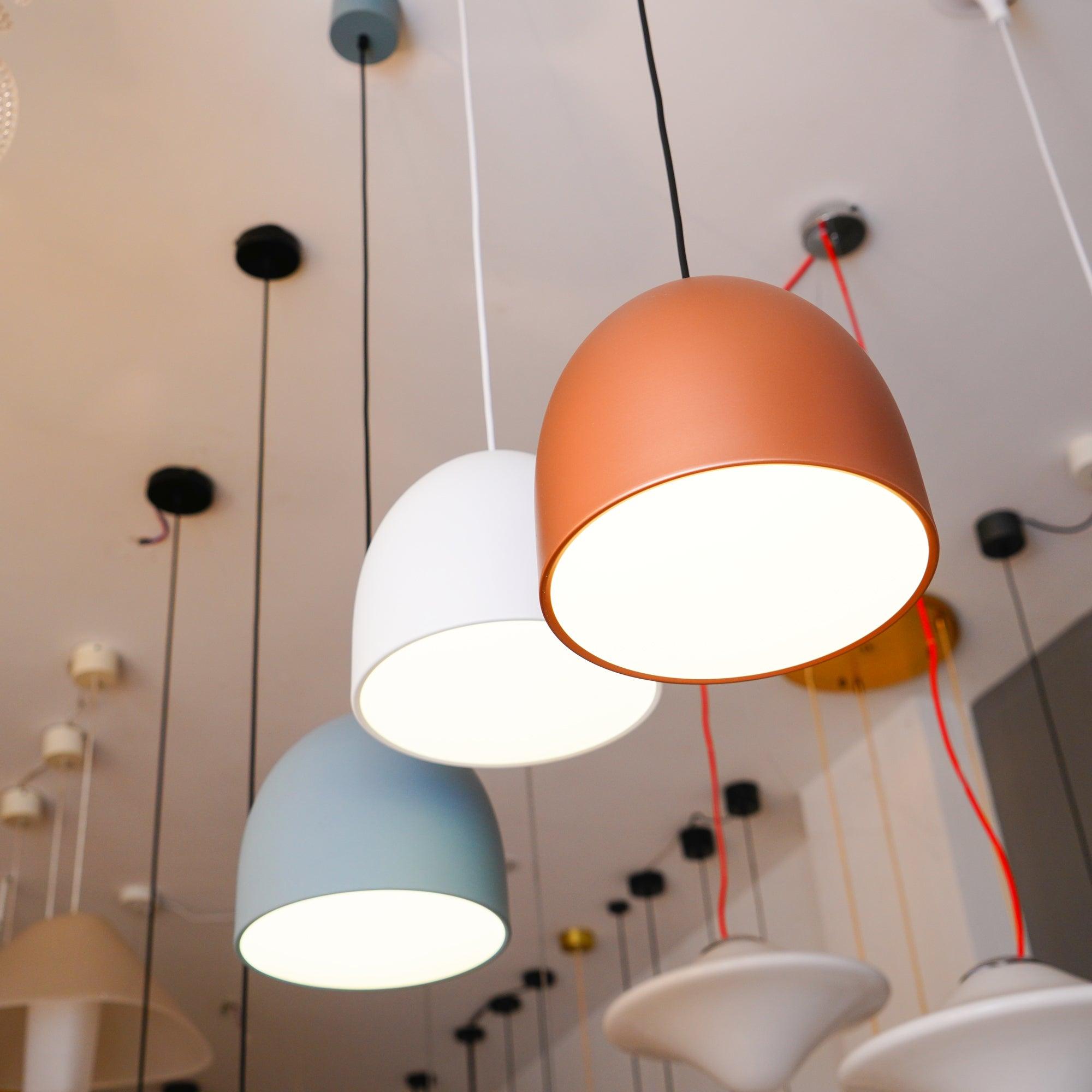Close view of illuminated lower faces of showroom bell shades