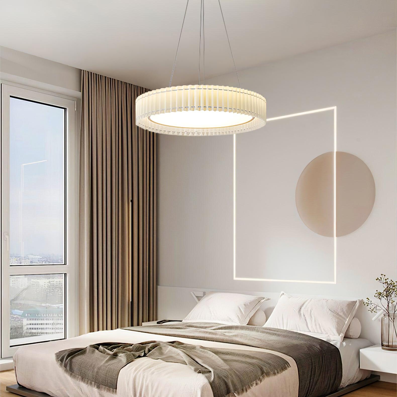 Round pleated pendant above a pale bed with circular wall art, geometric sunlight and taupe curtains