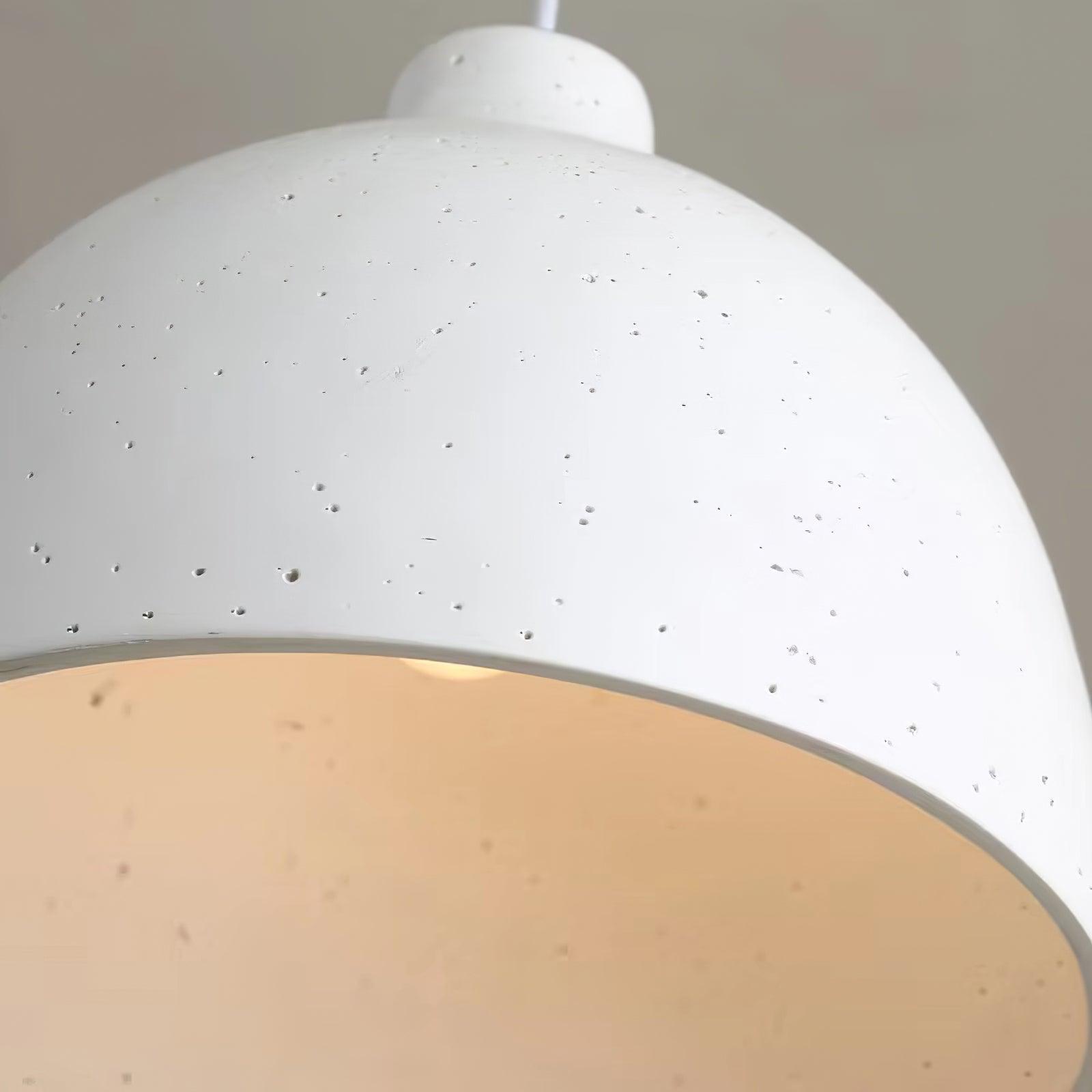 Close view of white speckled shade and open rim