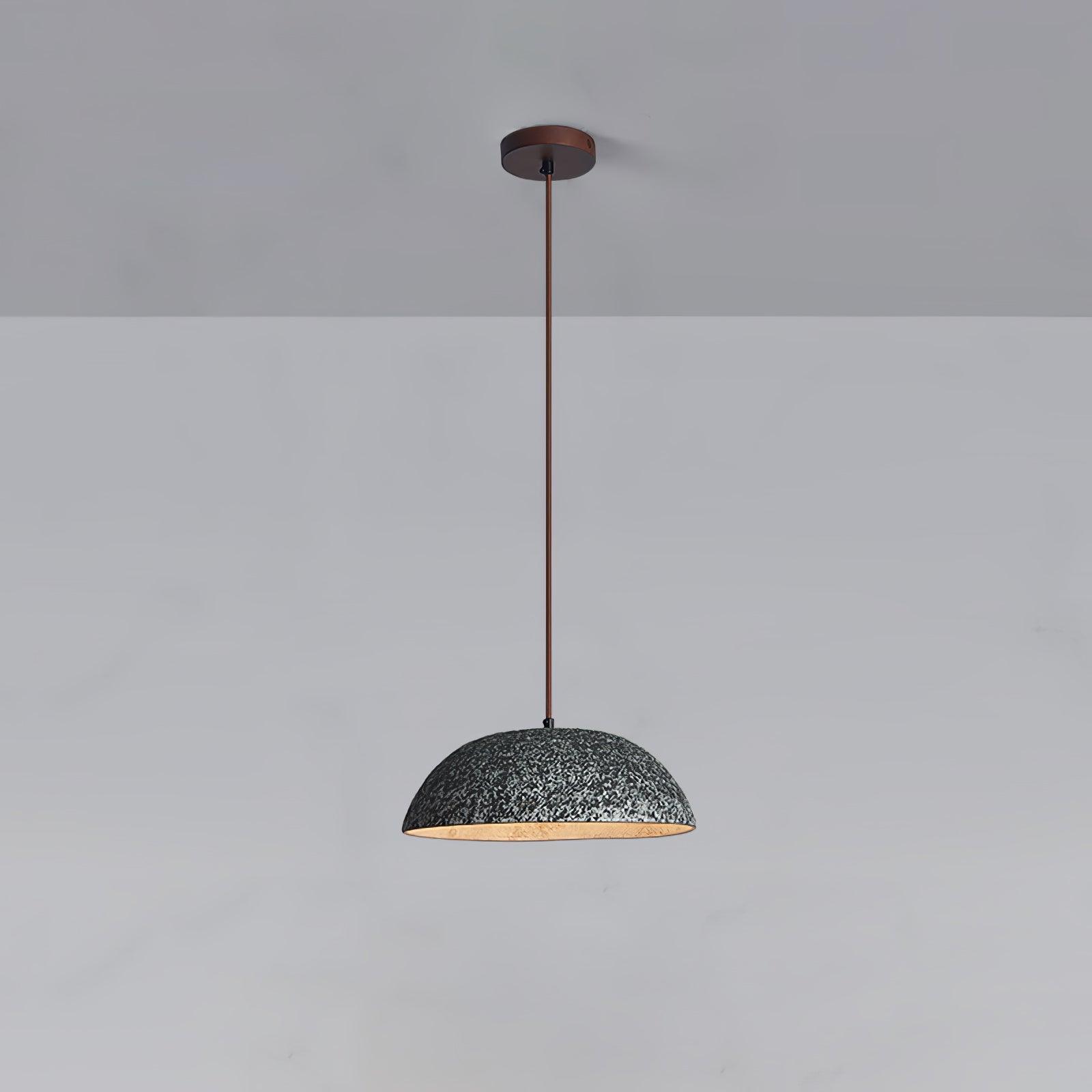 Black mottled ceramic dome pendant with a dark suspension cable and round canopy