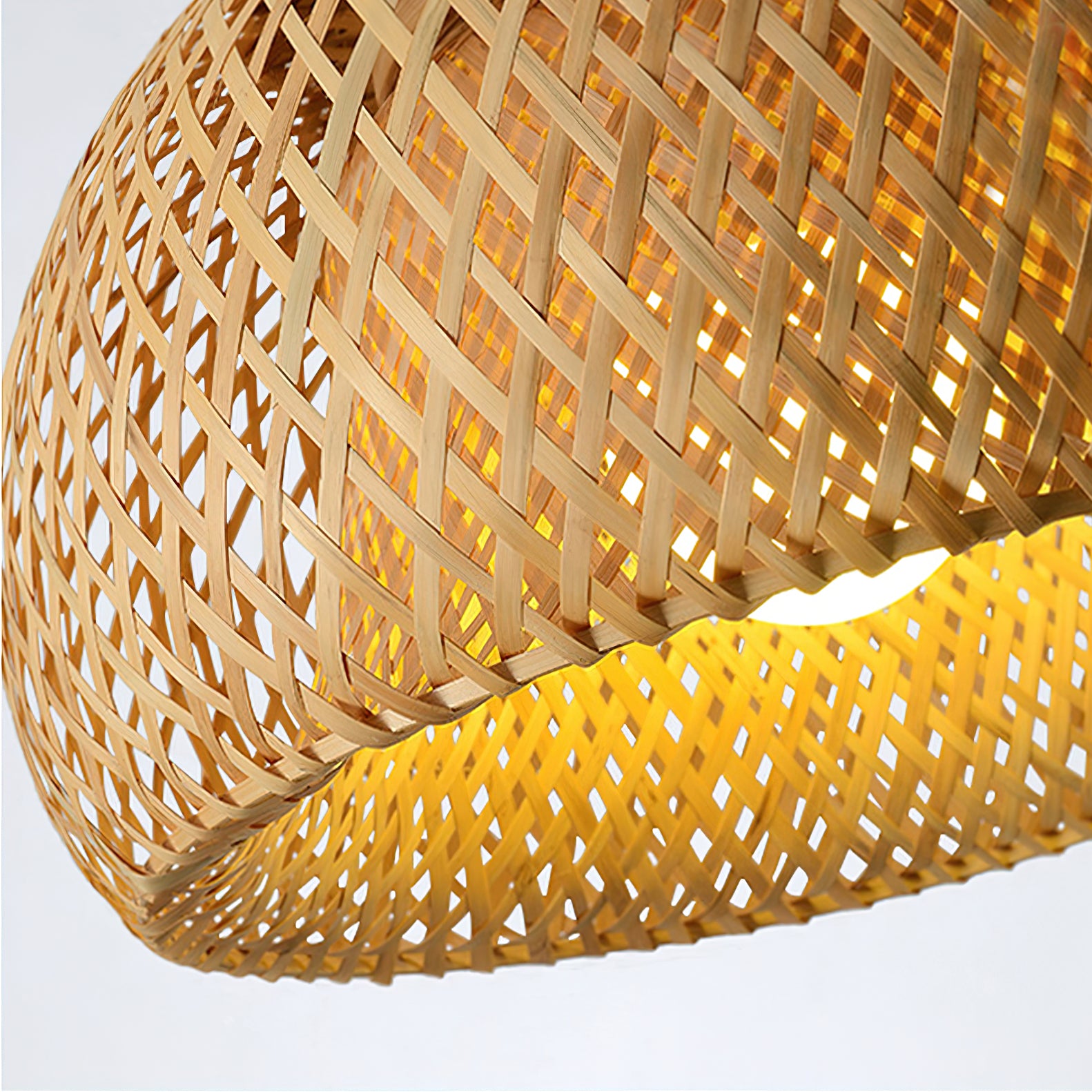 Detail of crossed bamboo strips, diamond openings and bound curved lower rim, with a bright bulb partly visible