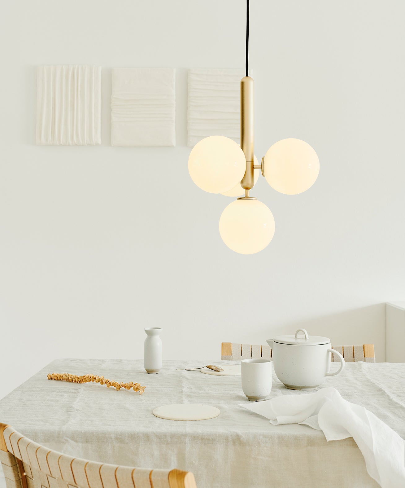 Compact white globe cluster above a dining table
