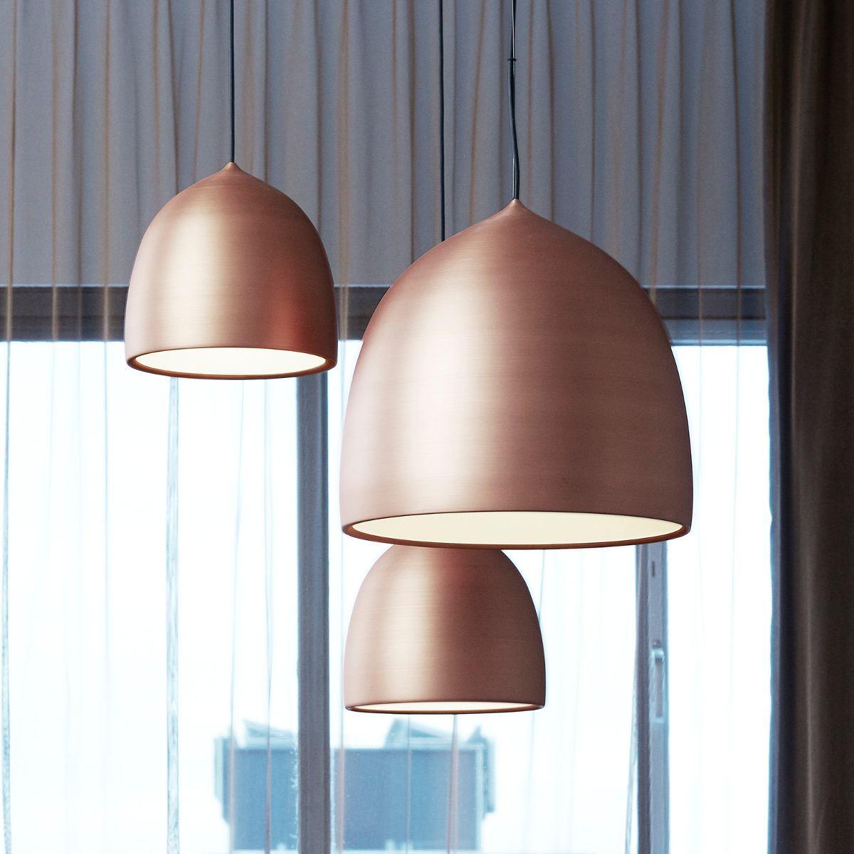 Close view of grouped copper-coloured bell shades