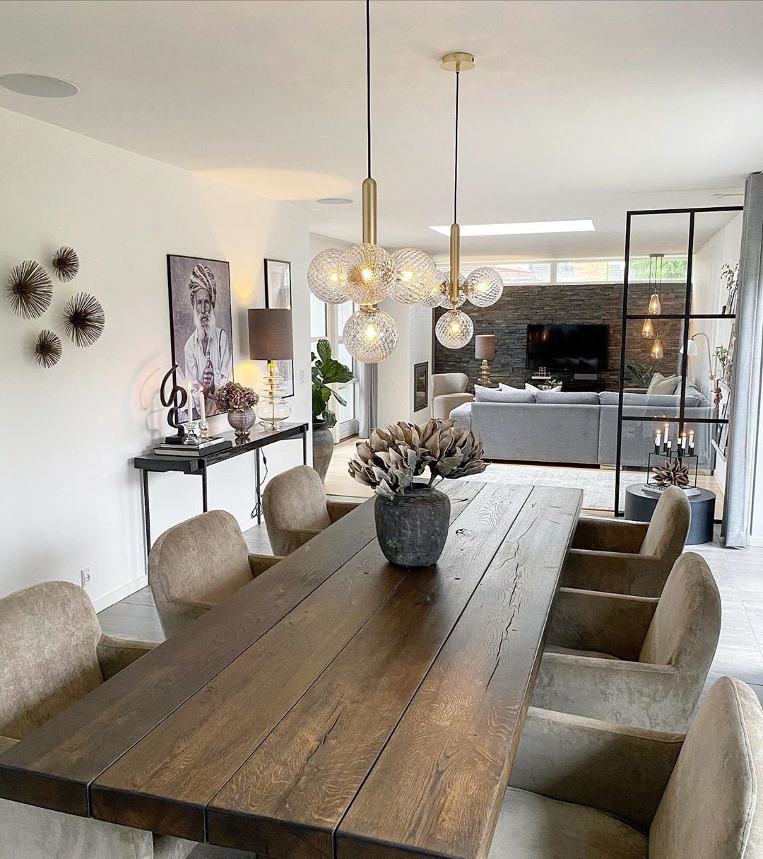 Clear globe pendants over a long wood table