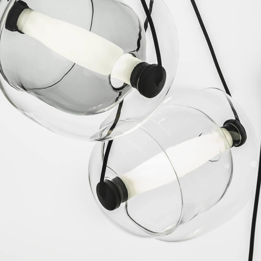 Clear glass capsules crossed by white light tubes