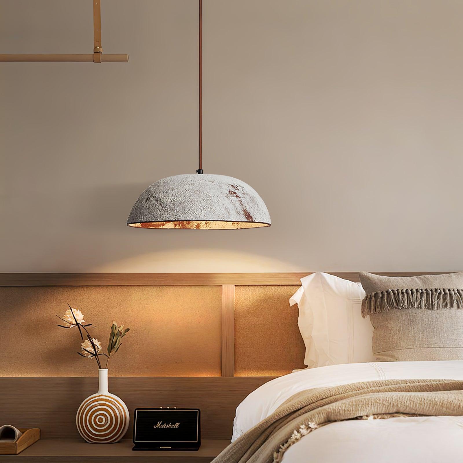 White ceramic dome suspended beside a bed