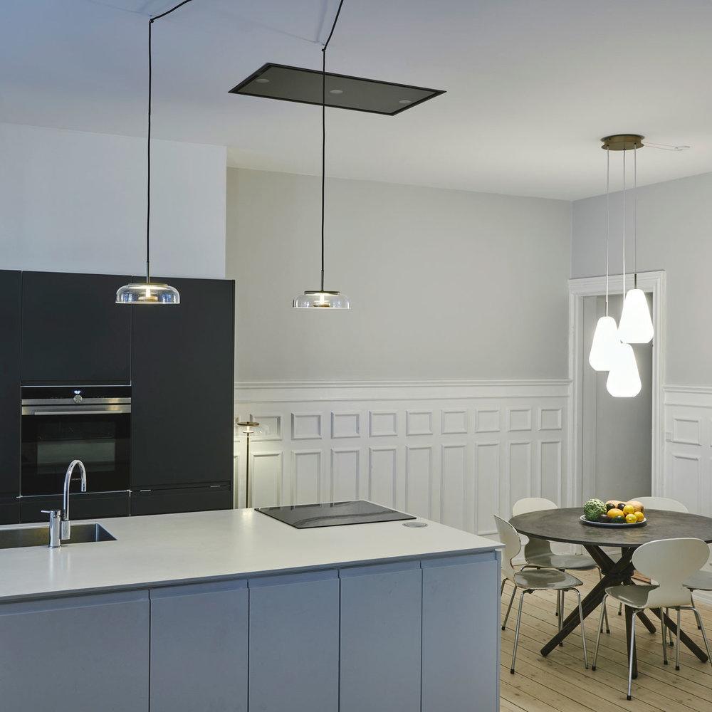 Blossi pendant light with a glass dome and circular inner metal elements