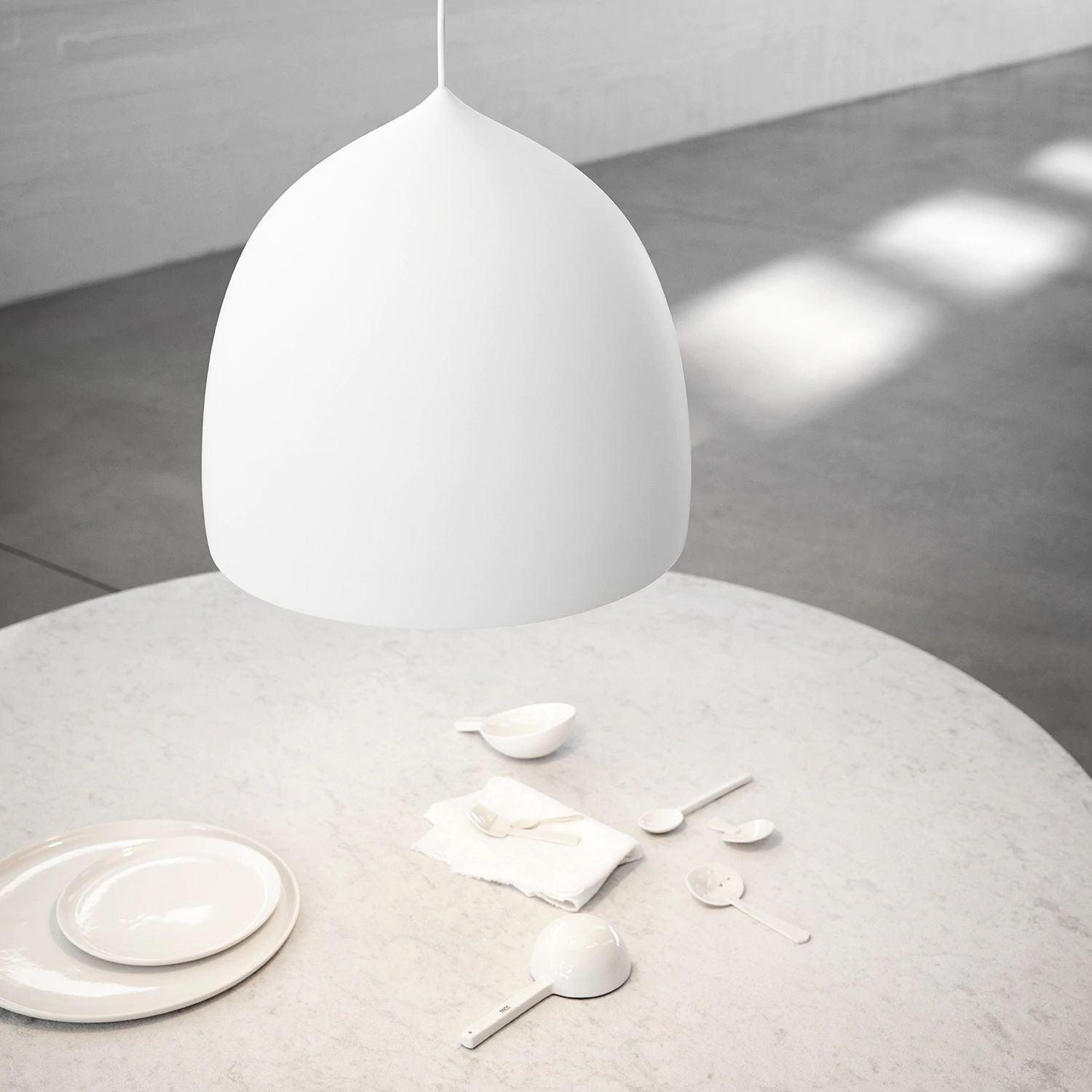White bell shade over a pale round table