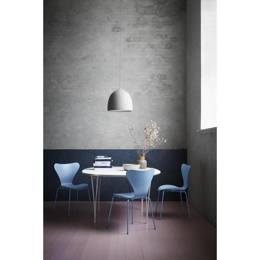 Single white pendant in a dark-walled dining area