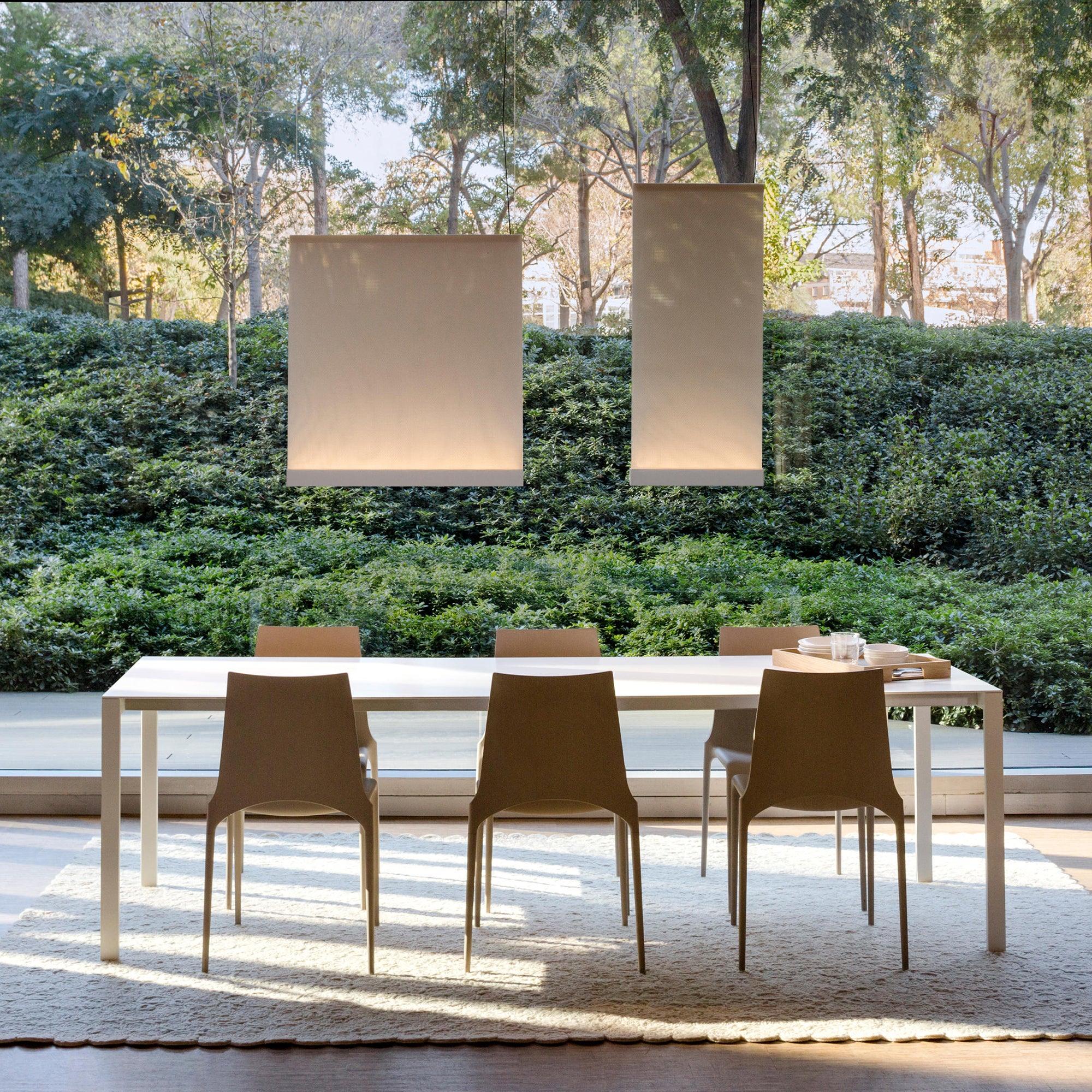 Two fabric pendants shown over a table in an outdoor scene