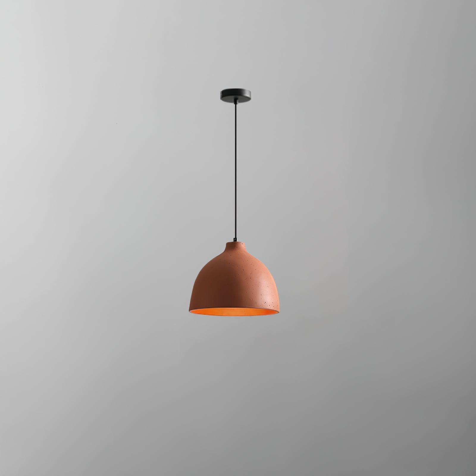 Orange bowl pendant on a dark cord beneath a round black canopy