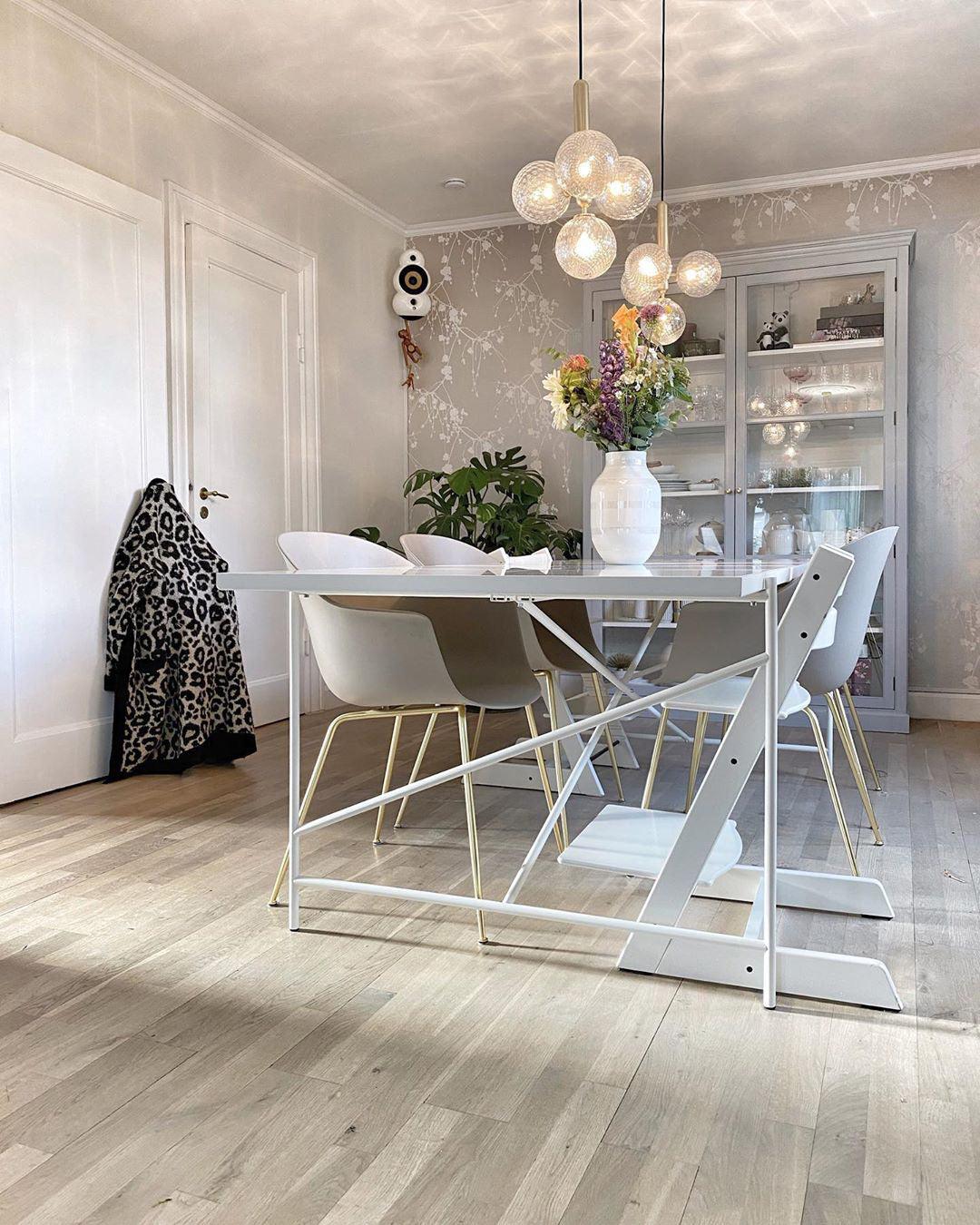 Glass globe lighting above a white dining setting
