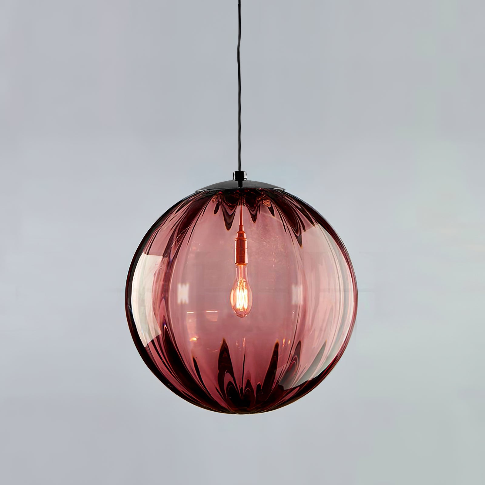 Paola pendant light with a coloured glass globe and small metal cap
