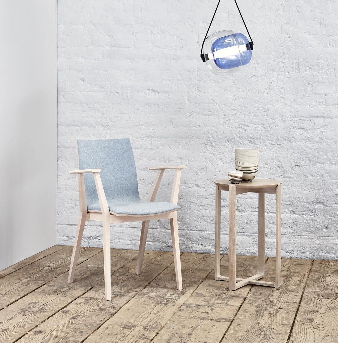 Single blue glass capsule above a chair