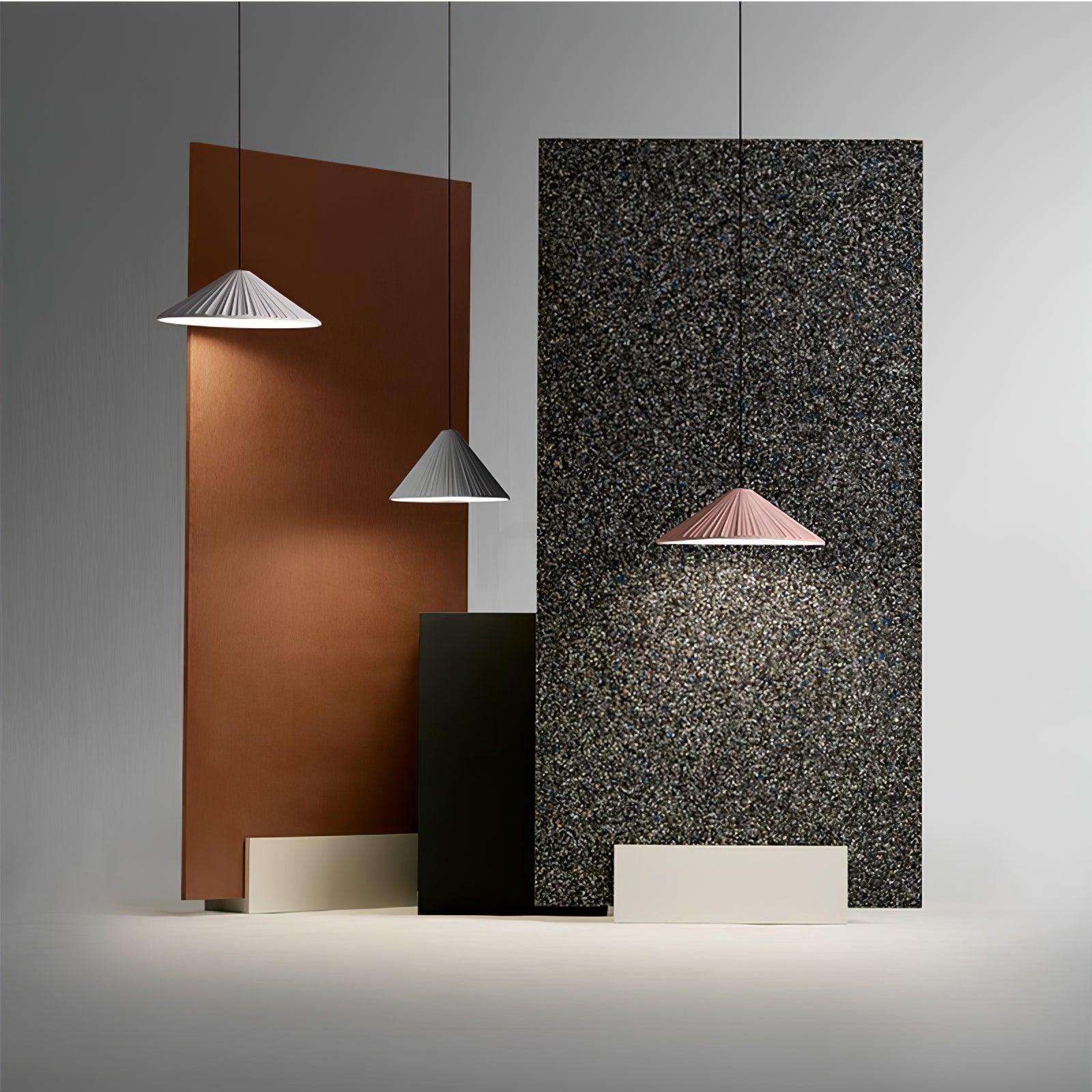 Small coloured pendants against geometric wall panels