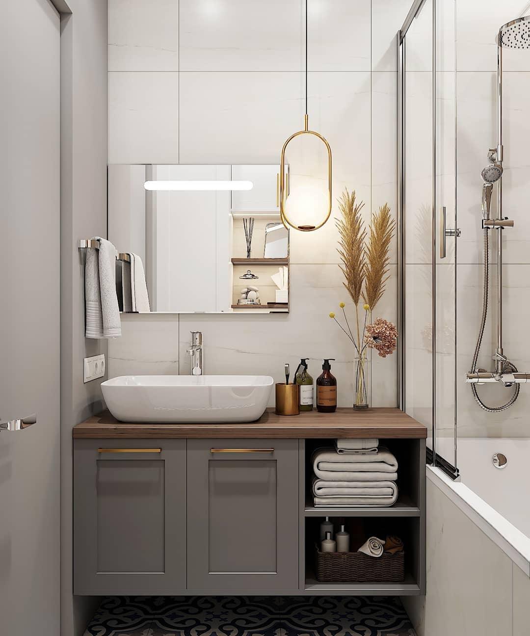 Oval frame pendant beside a bathroom mirror