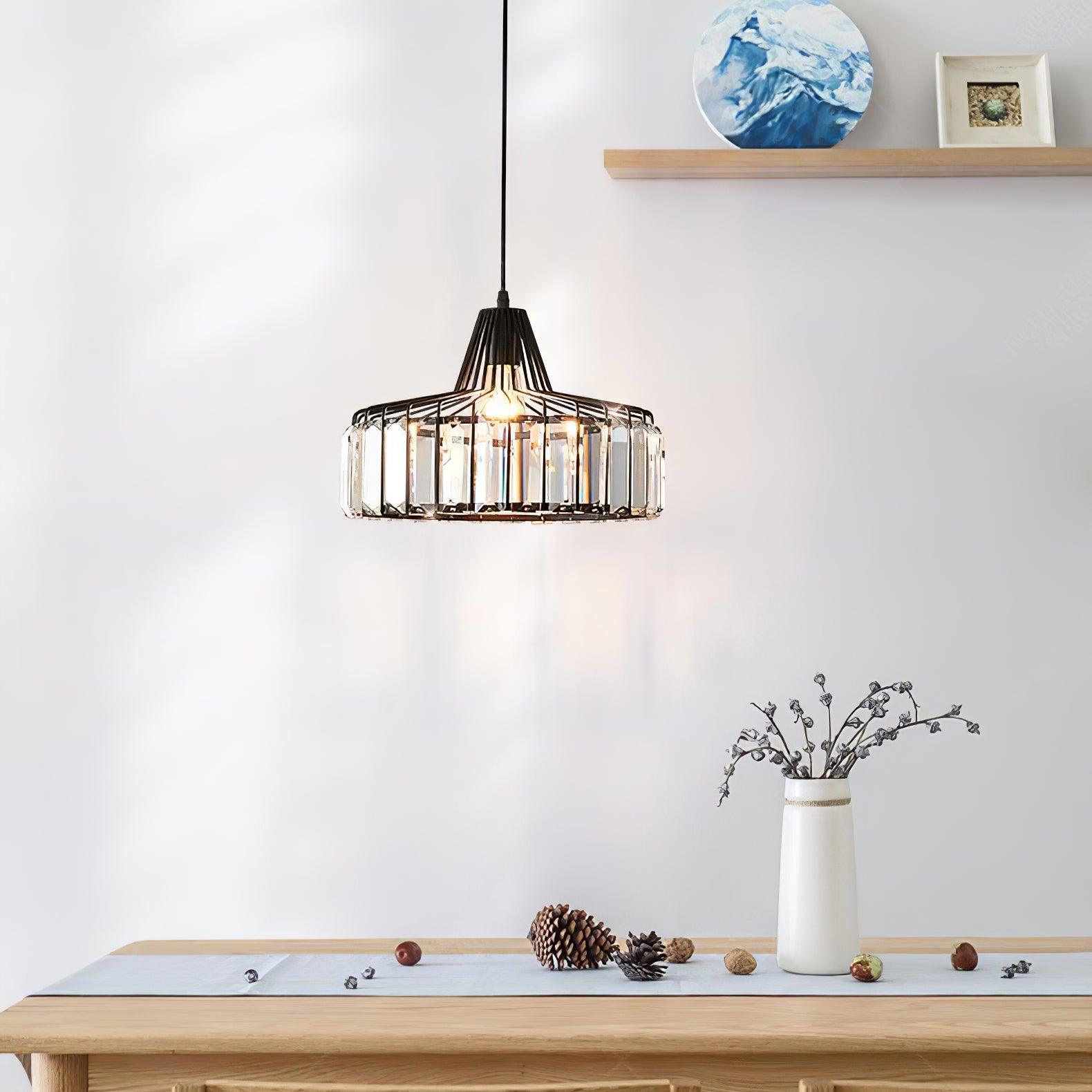 Black crystal-glass pendant above a pale wooden console